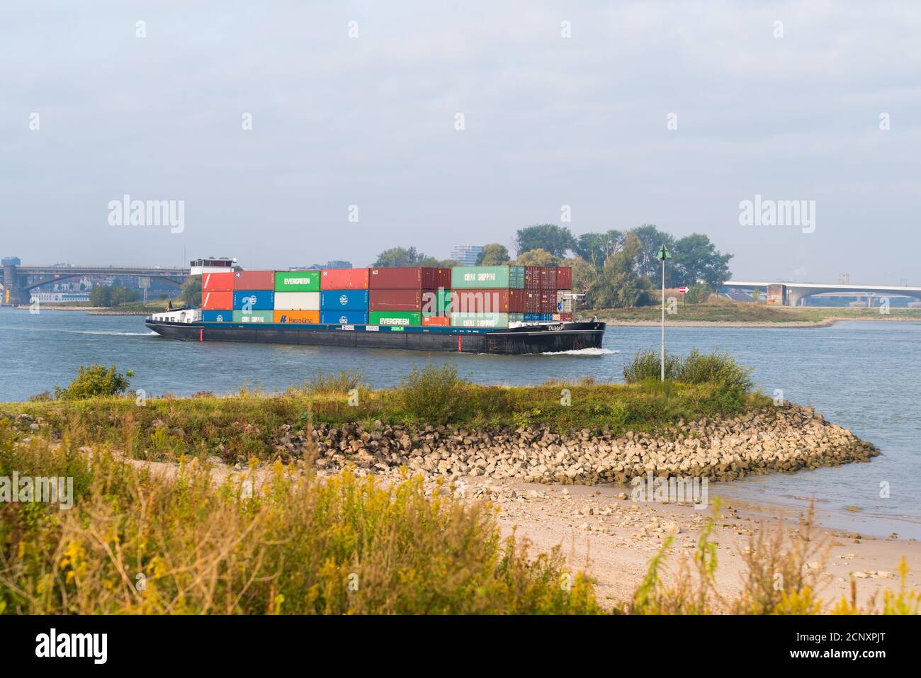 NIJMEGEN, NETHERLANDS - SEPTEMBER 12, 2020: Container ship on the Waal river heading to Germany Stock Photo