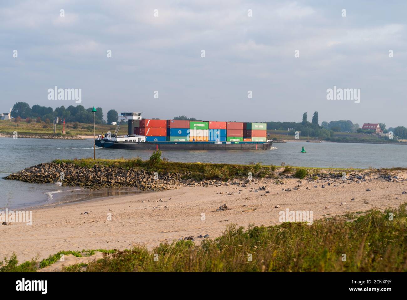 NIJMEGEN, NETHERLANDS - SEPTEMBER 12, 2020: Container ship on the Waal river heading to Germany Stock Photo