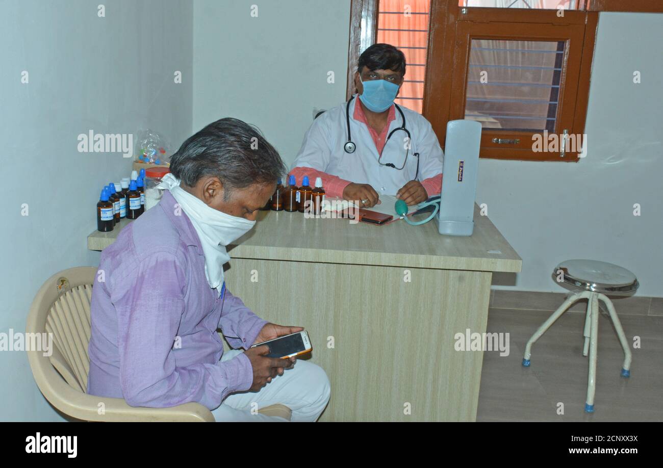 Indian doctor treating patient hi-res stock photography and images - Alamy