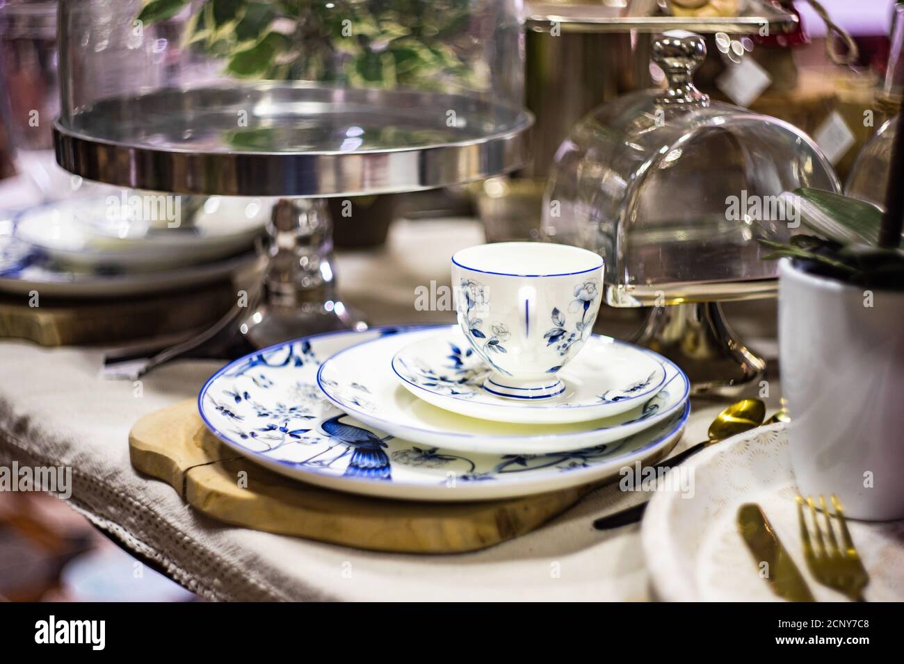 Rustic tableware with variety of plates and cups on a table Stock Photo