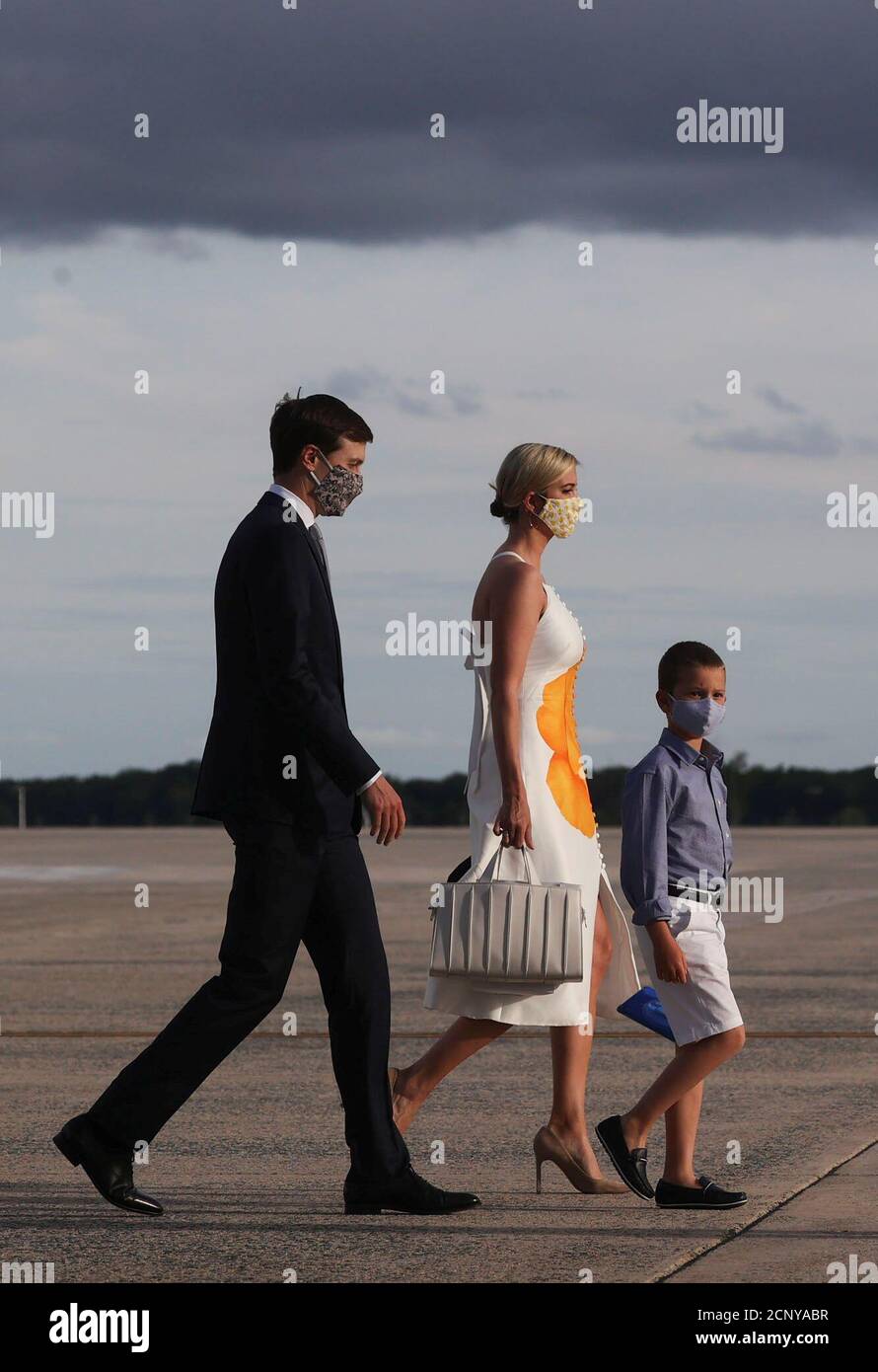 White House senior advisers Jared Kushner and Ivanka Trump and their son  Joseph wear protective face masks as they walk away from Air Force One  returning to Washington with her father U.S.