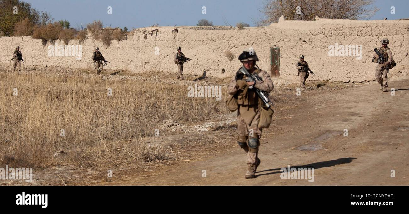 U.S. Marines, attached to the 2nd Battalion 2nd Marines from Camp Lejeune, North Carolina, pursue militants during an operation in Garmsir district of Helmand Province December 20, 2009.   REUTERS/Adrees Latif   (AFGHANISTAN - Tags: POLITICS MILITARY) Stock Photo