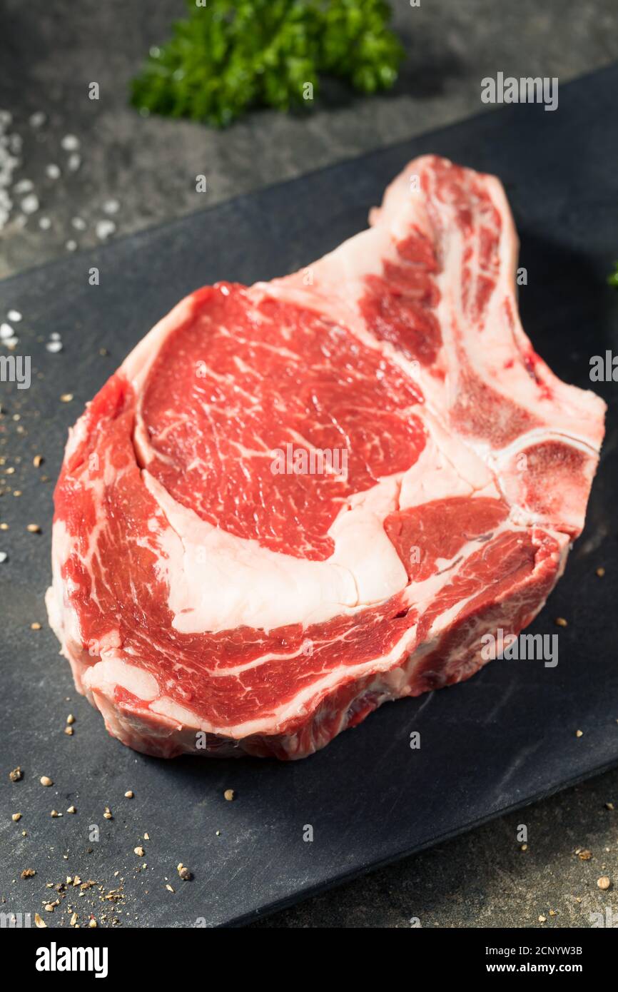 Raw Grass Fed Ribeye Steak with Salt and Pepper Stock Photo Alamy