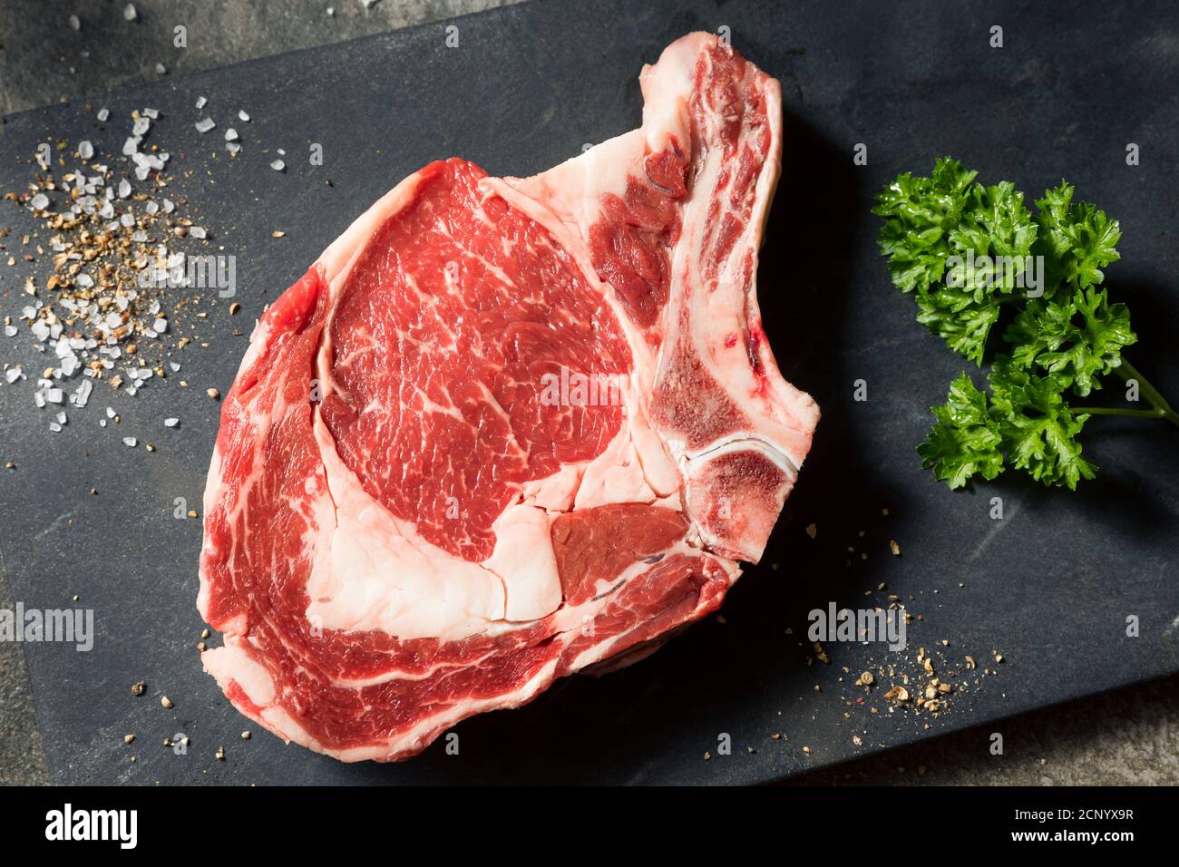 Raw Grass Fed Ribeye Steak with Salt and Pepper Stock Photo Alamy