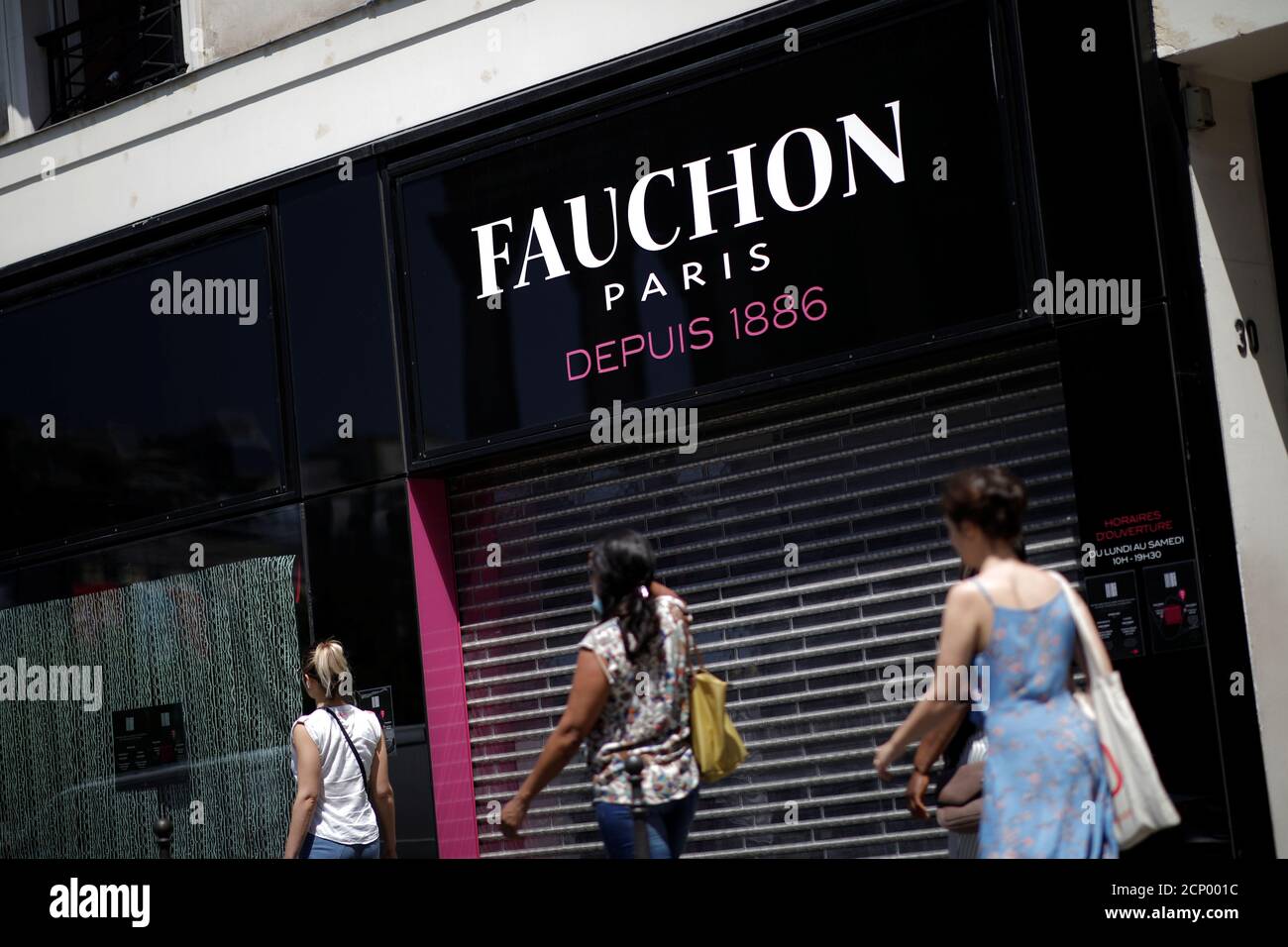 People walk past a closed store of French fine food group Fauchon in Paris,  France, June 24, 2020. REUTERS/Benoit Tessier Stock Photo - Alamy