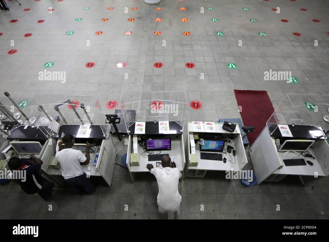 Airline staff members are seen at their desks at the Nnamdi Azikiwe International airport during preparation ahead of the reopening of the airport for domestic flight operations that is scheduled for July 8, 2020 in Abuja, Nigeria July 6, 2020. REUTERS/Afolabi Sotunde Stock Photo