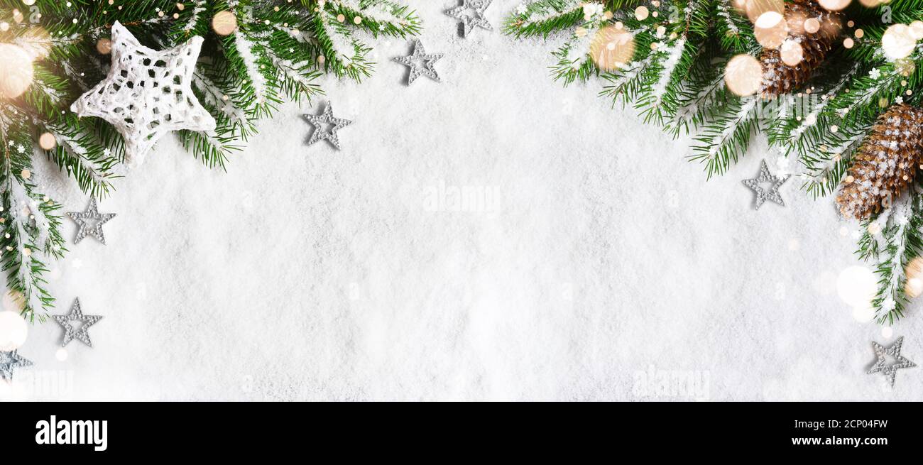 Christmas background, green pine branches, cones on snow background and ...