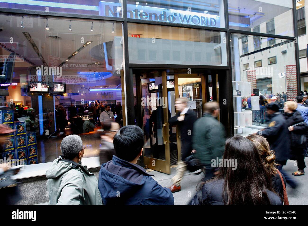 Customers wait in line to purchase the Wii game console outside the  Nintendo store in midtown Manhattan, New York, November 21, 2007. The  Nintendo Wii console is the top-selling game console. REUTERS/Brendan