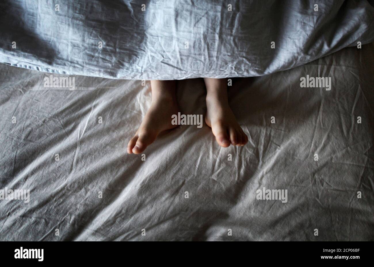 Four-year-old Morgan Wimborne sleeps at home in Sydney, May 15, 2012. Photographer Tim Wimborne took the photo early morning for the A Day project before leaving for an assignment in Afghanistan. Pictures of a house in India, a food cupboard in New Zealand and someone eating breakfast in Sweden were among the first of thousands of photographs sent to an Internet project to capture a day in the life of people all over the world on Tuesday. The Swedish-based project, www.aday.org , has got backing from figures in entertainment, politics and business, who are also going to upload photos of their  Stock Photo