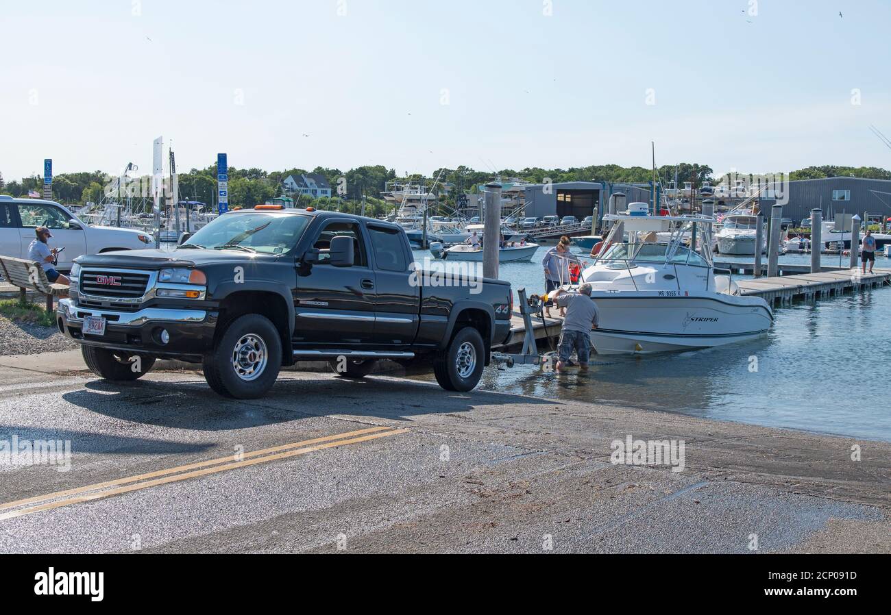Launching a boat in Sesuit Harbor in Dennis, Massachusetts, USA on Cape Cod Stock Photo