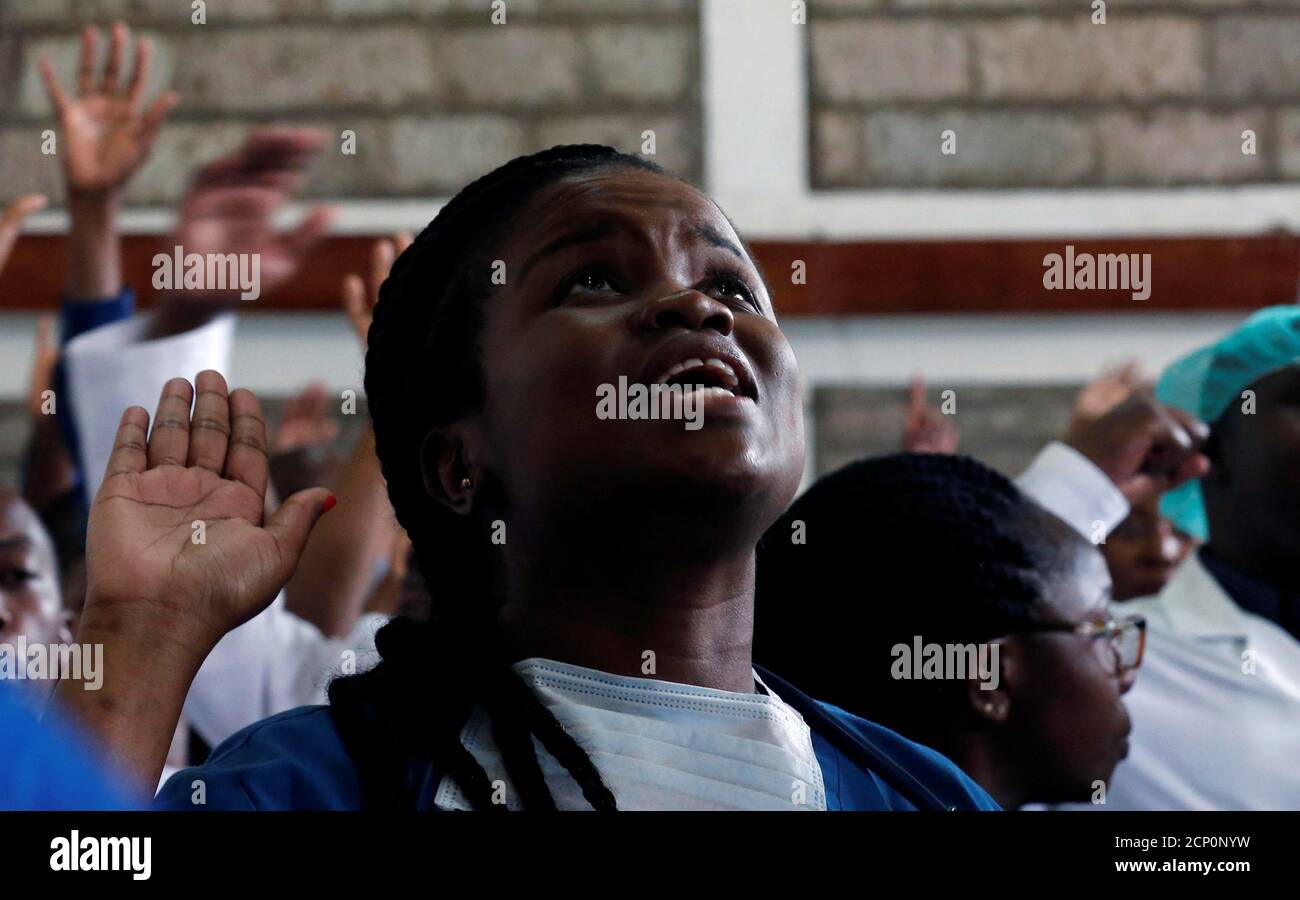 A Kenyan doctor reacts during a meeting to demand fulfilment of a 2013 agreement between their union and the government that would raise their pay and improve working conditions in Nairobi, Kenya December 5, 2016. REUTERS/Thomas Mukoya Stock Photo