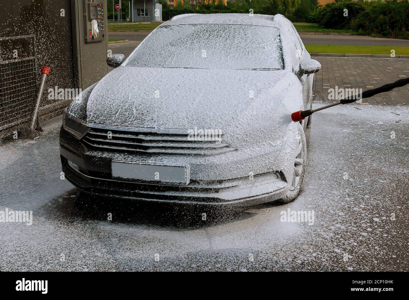 The car owner wash selfservice with foam in washes a self service car