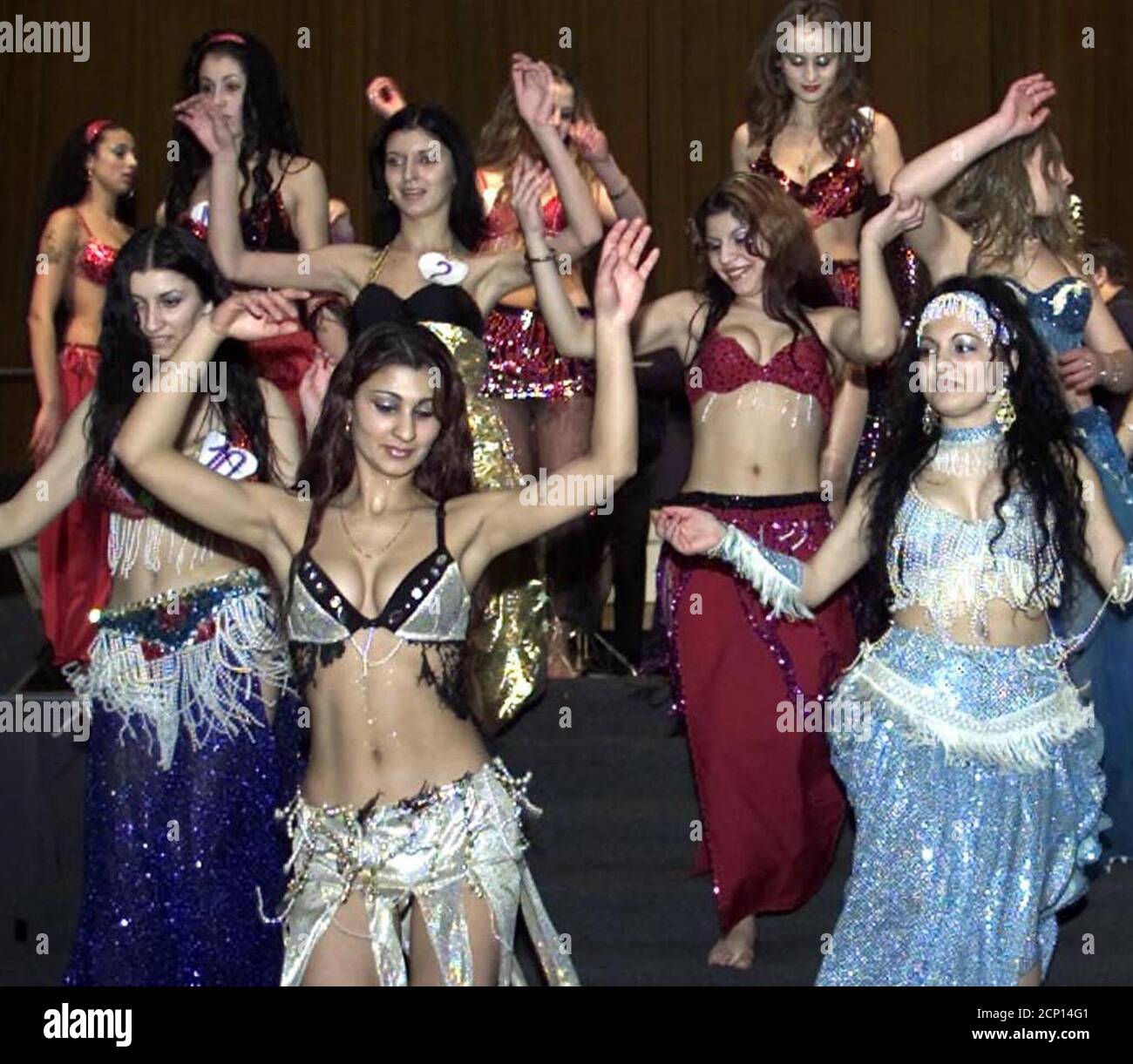 Romanian gypsy girls perform a belly dance on the stage January 20, 2002  during the Miss Gipsy contest in Bucharest. The gipsies are electing their  Miss not only by their beauty but