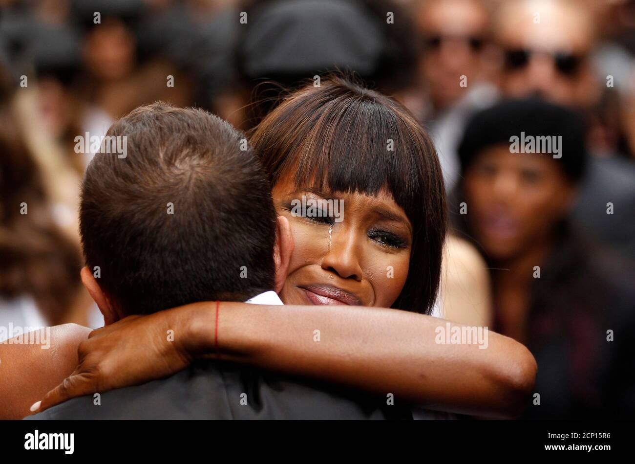 British model Naomi Campbell (R) crying as she embrace Italian designer  Stefano Gabbana during a party marking the 25th anniversary of her career  in downtown Milan September 26, 2010. REUTERS/Stefano Rellandini (ITALY -