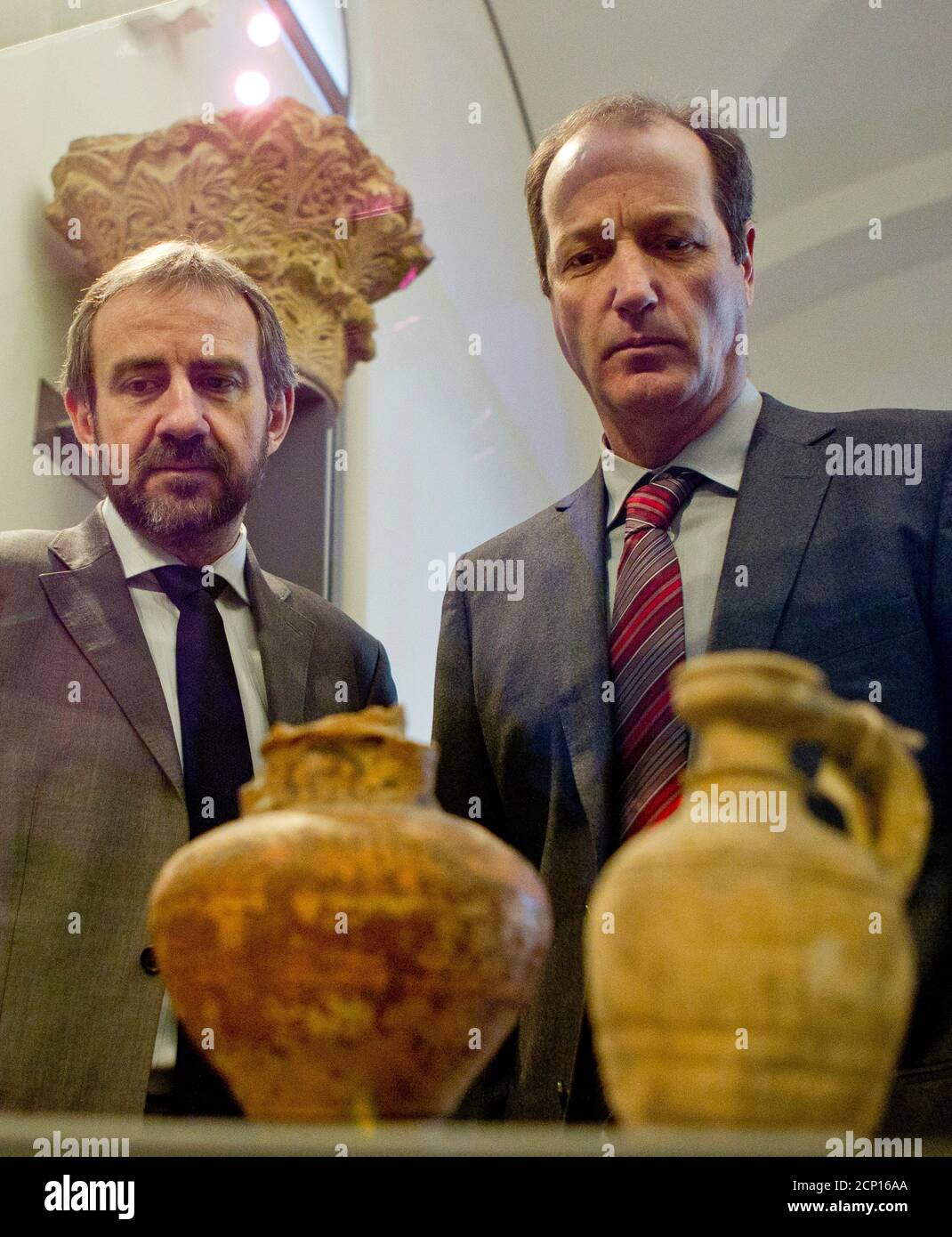 Hermann Parzinger (L) of the Prussian Cultural Heritage Foundation and Dietrich Raue of the Egyptian Museum at Leipzig University look at objects of the late antique-byzantine period during their presentation at the Bode Museum in Berlin, February 6, 2012.  The Bode Museum on Monday displayed 40 late antique-byzantine household objects, belonging to its pre-World War Two inventory, after they were returned from the Egyptian Museum of the University of Leipzig where they had been stored since the Soviet Union restituted the items to former East Germany in 1958.    REUTERS/Thomas Peter (GERMANY  Stock Photo