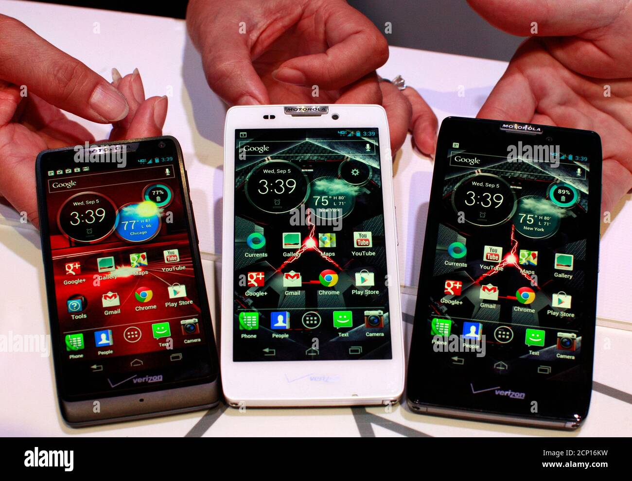 Product specialists display new Motorola droid phones; (L-R) Droid Razor M, Droid Razor HD and the Droid Razor Maxx HD during a launch event in New York, September 5, 2012.  REUTERS/Brendan McDermid (UNITED STATES - Tags: BUSINESS TELECOMS SCIENCE TECHNOLOGY) Stock Photo