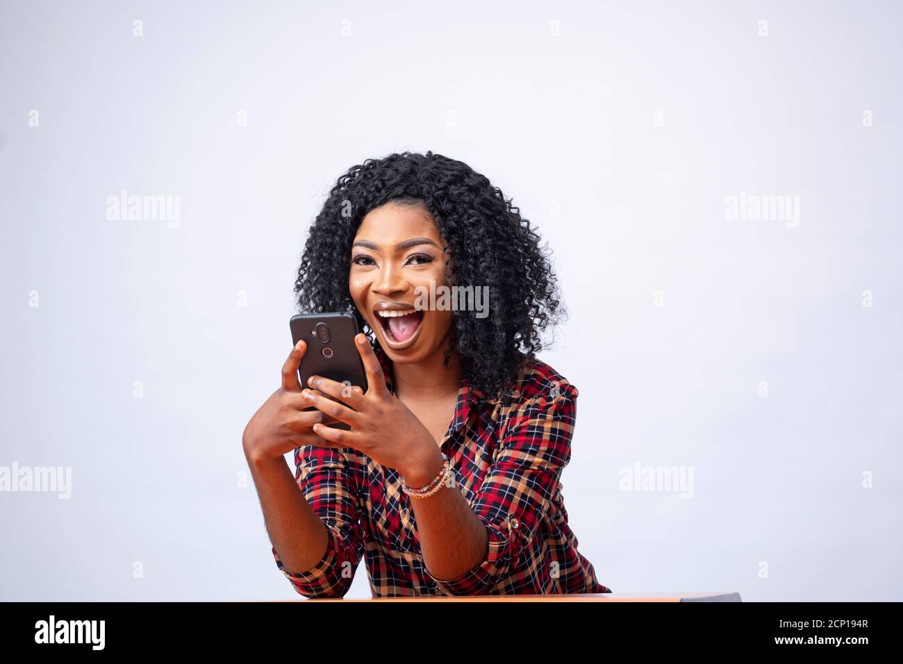 happy young african lady using her phone Stock Photo