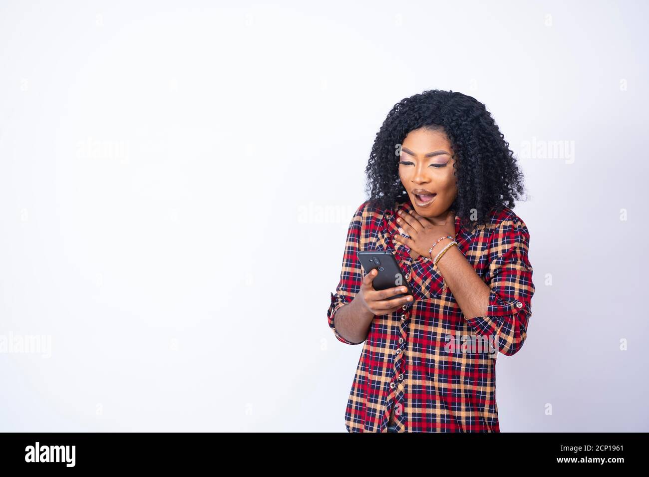 young back woman holding her phone looking shocked and worried Stock Photo
