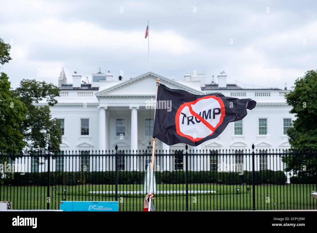 A man waves an anti-Trump flag in front of the White House on the day that the White House Siege was supposed to happen but was cancelled. Stock Photo