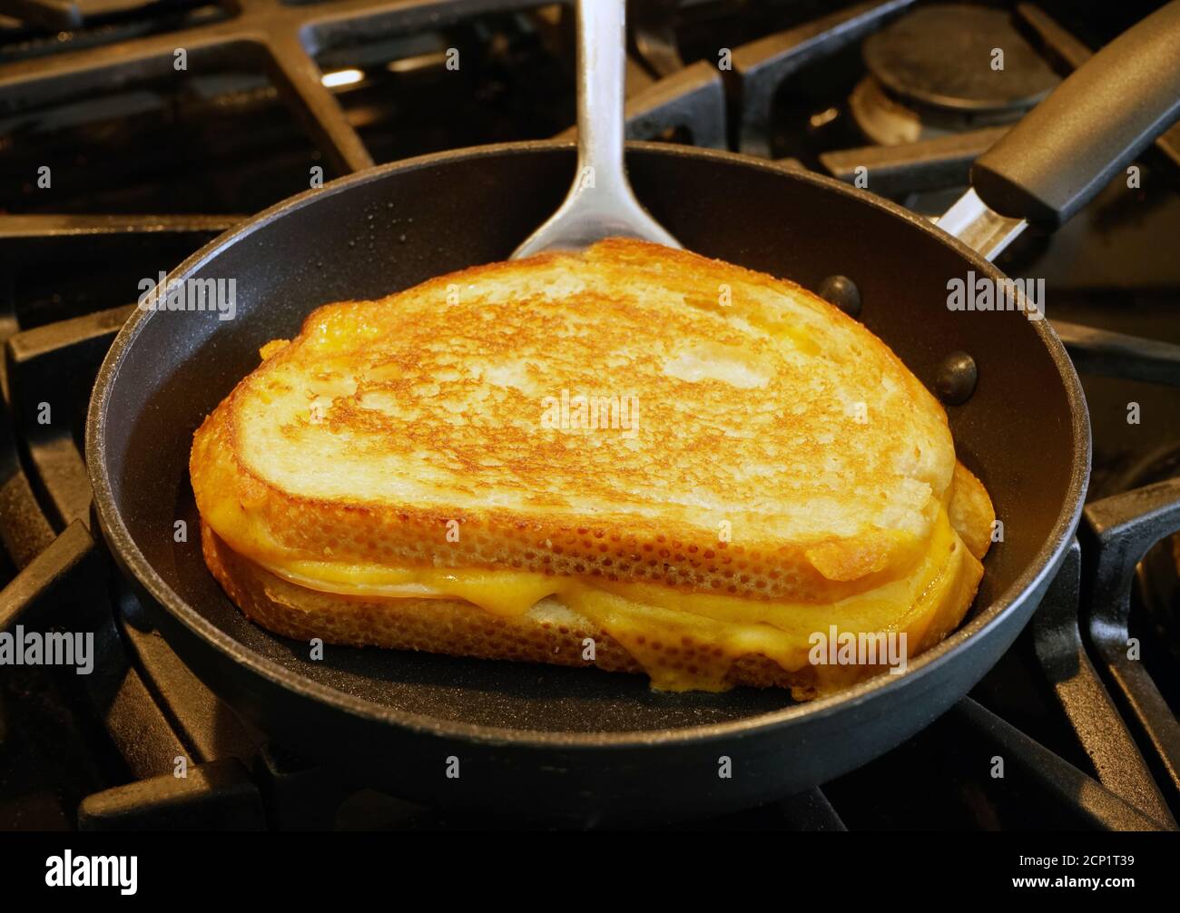 Antagonist affix Lodge Grilled cheese sandwich being grilled in frying pan Stock Photo - Alamy
