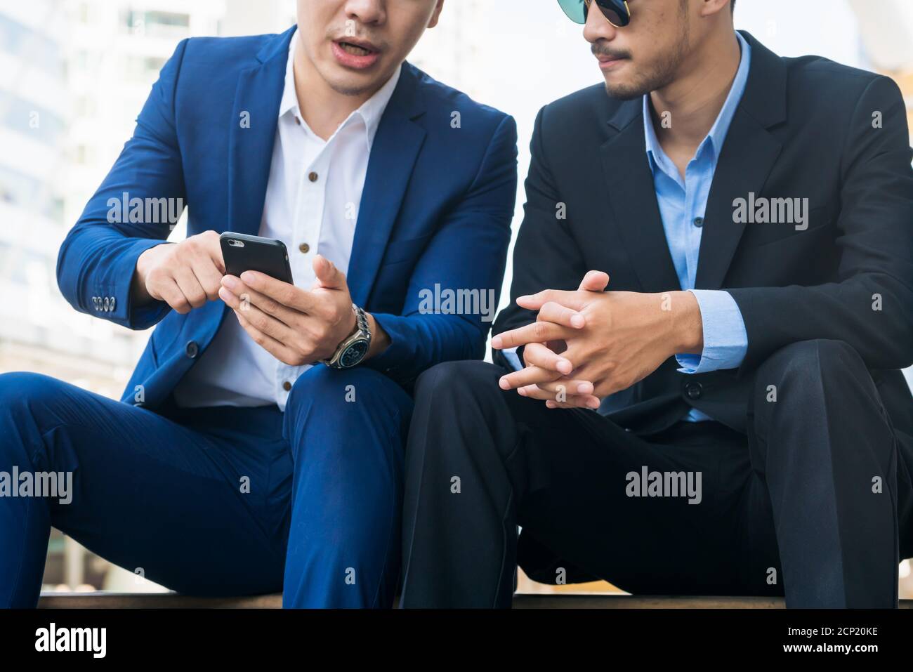 Two business people discuss business affair on mobile phone