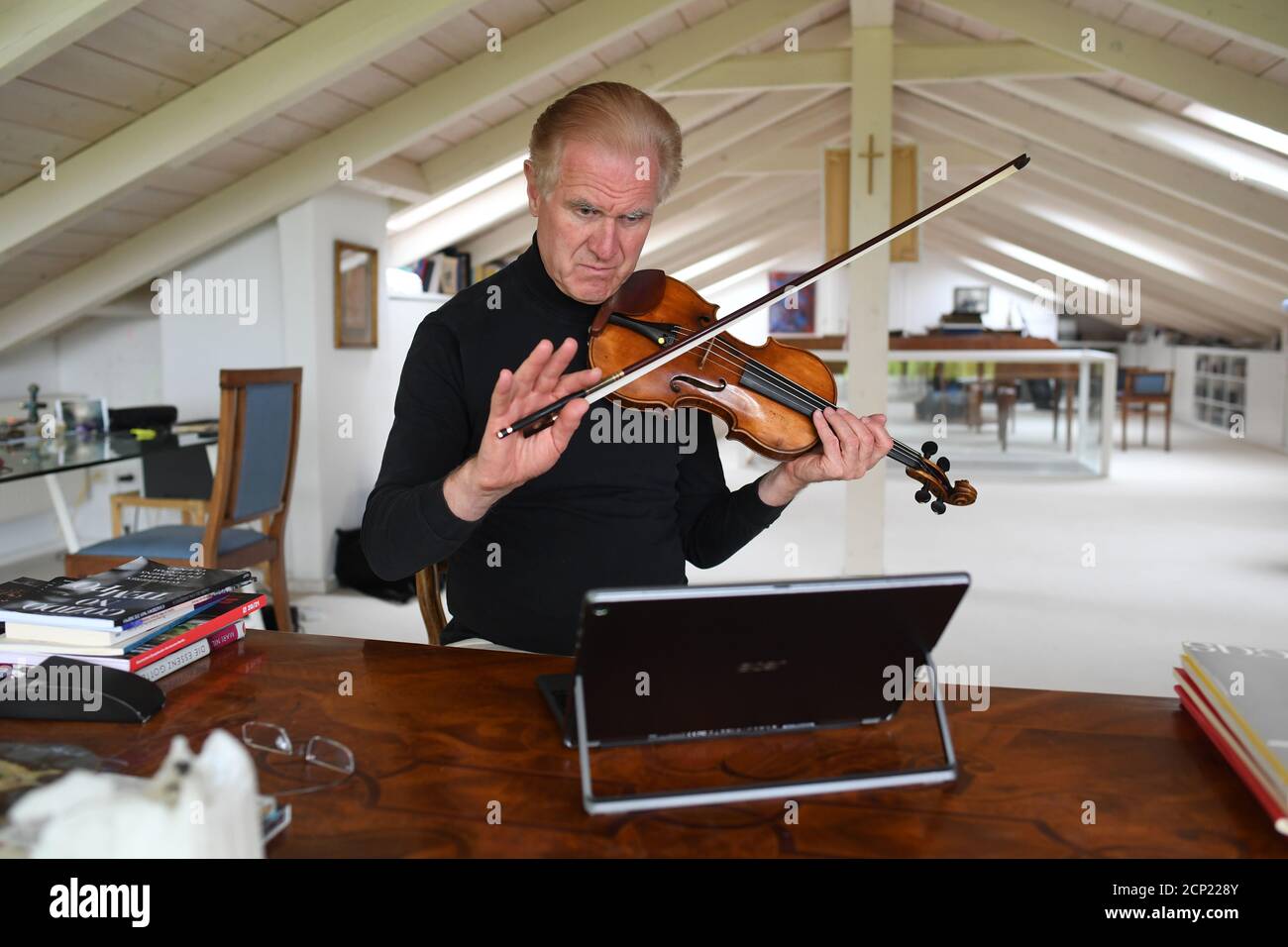 Conductor and violinist Christoph Poppen gives online singing and music  lessons, as the spread of the coronavirus disease continues in Diessen,  Germany, May 4, 2020. Picture taken May 4, 2020. REUTERS/Andreas Gebert