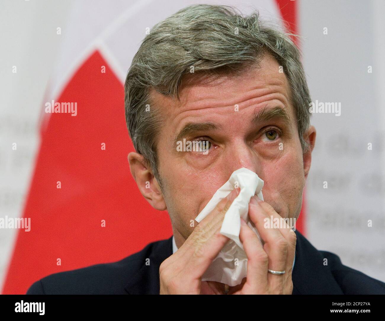 Thomas Zeltner, Director of the Federal Office of Public Health (BAG) blows his nose during a news conference on the popular vote ' Yes to the complementary medicine' ('Ja zur Komplementaermedizin') in Bern April 9, 2009. REUTERS/Pascal Lauener (SWITZERLAND POLITICS HEADSHOT) Stock Photo