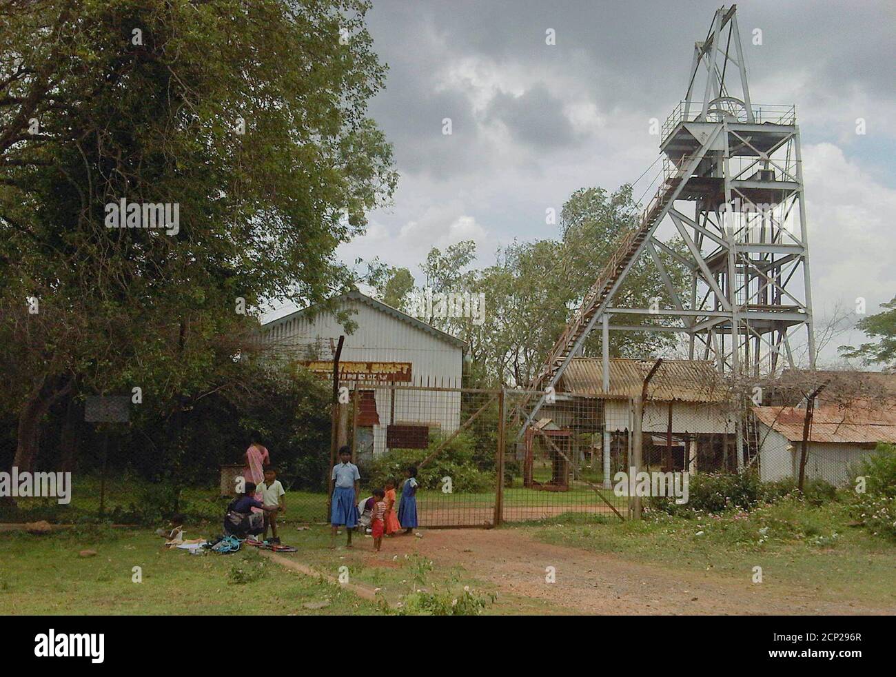 Schoolchildren play in front of an abandoned shaft at Kolar Gold Fields