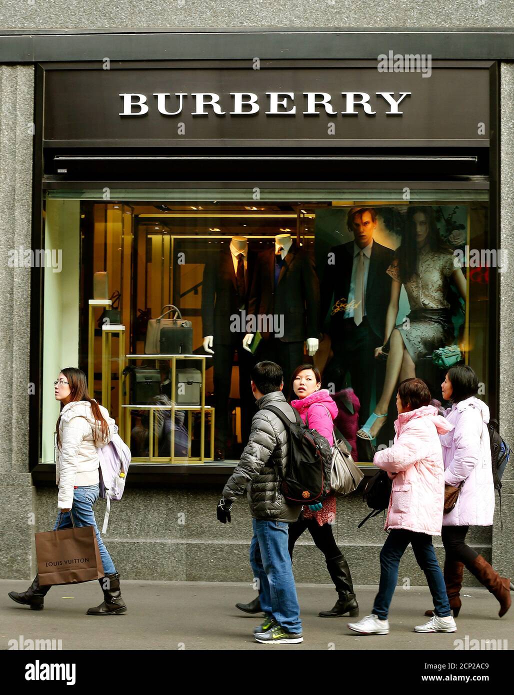 People walk past a store of British luxury brand Burberry at the  Bahnhofstrasse shopping street in Zurich January 15, 2013. Burberry posted  a 14 percent rise in underlying retail revenue in the