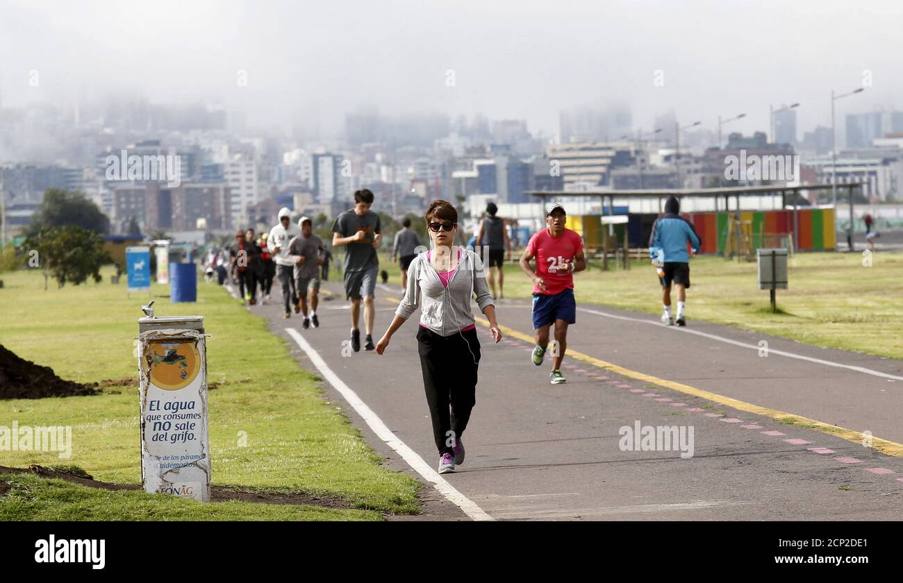 People jog at the site of the former Quito airport, which was converted into a recreational area named Bicentenario park, in Quito March 6, 2016. REUTERS/Guillermo Granja Stock Photo