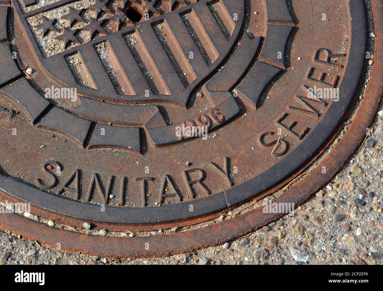 A cast iron sewer manhole cover in New Mexico, USA. Stock Photo