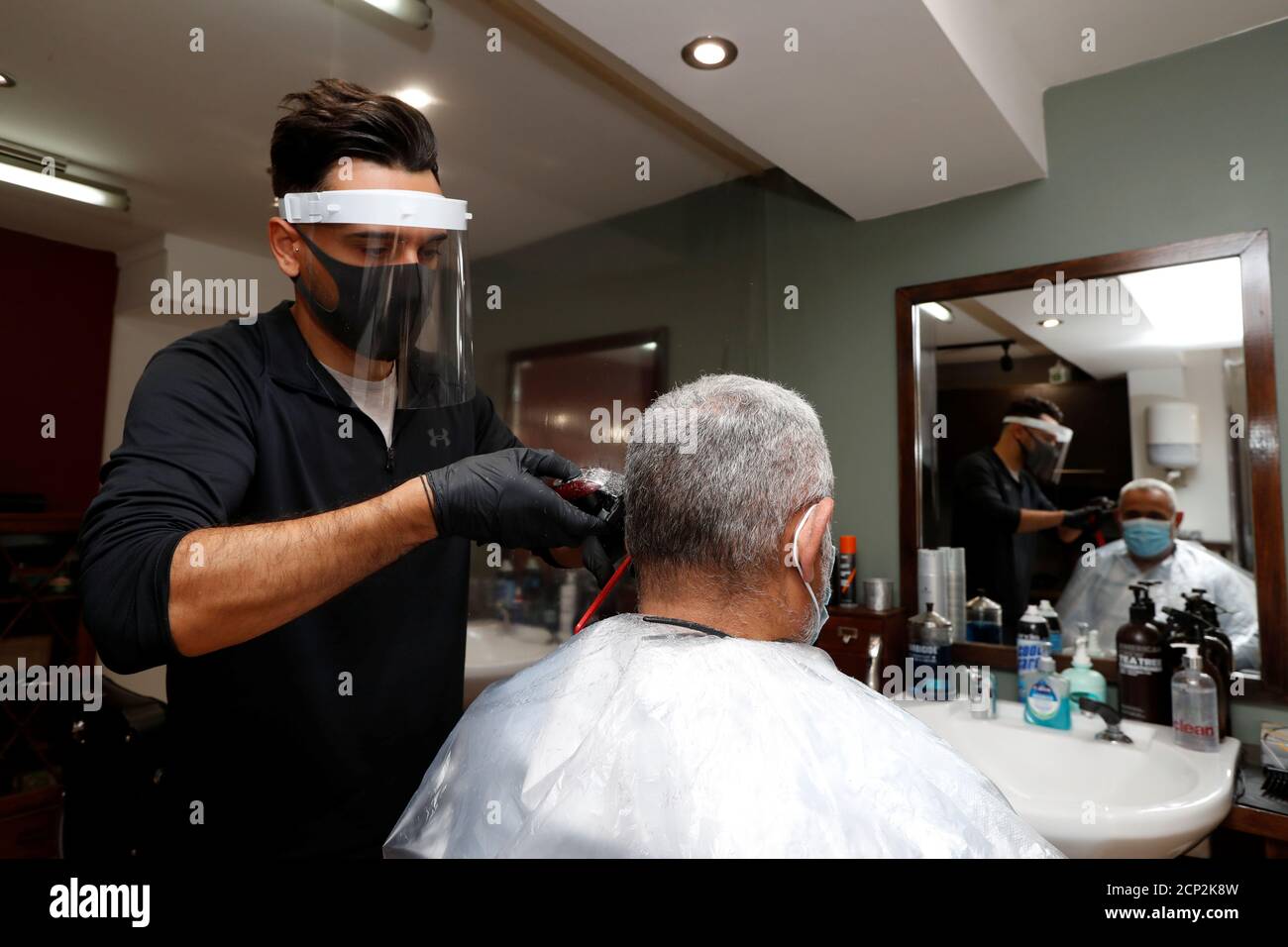 Barber Charlie Christo cuts fellow barber Shaun Dracos' hair before they  reopen, amid the coronavirus disease (COVID-19) outbreak, in St. Albans,  Britain, July 1, 2020. REUTERS/Paul Childs Stock Photo - Alamy