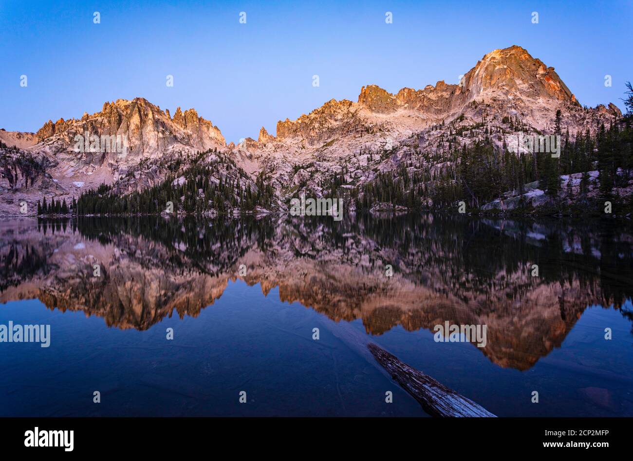 Baron Peak reflected in Baron Lake during the blue hour before sunrise, Sawtooth Wilderness, Idaho, USA. Stock Photo
