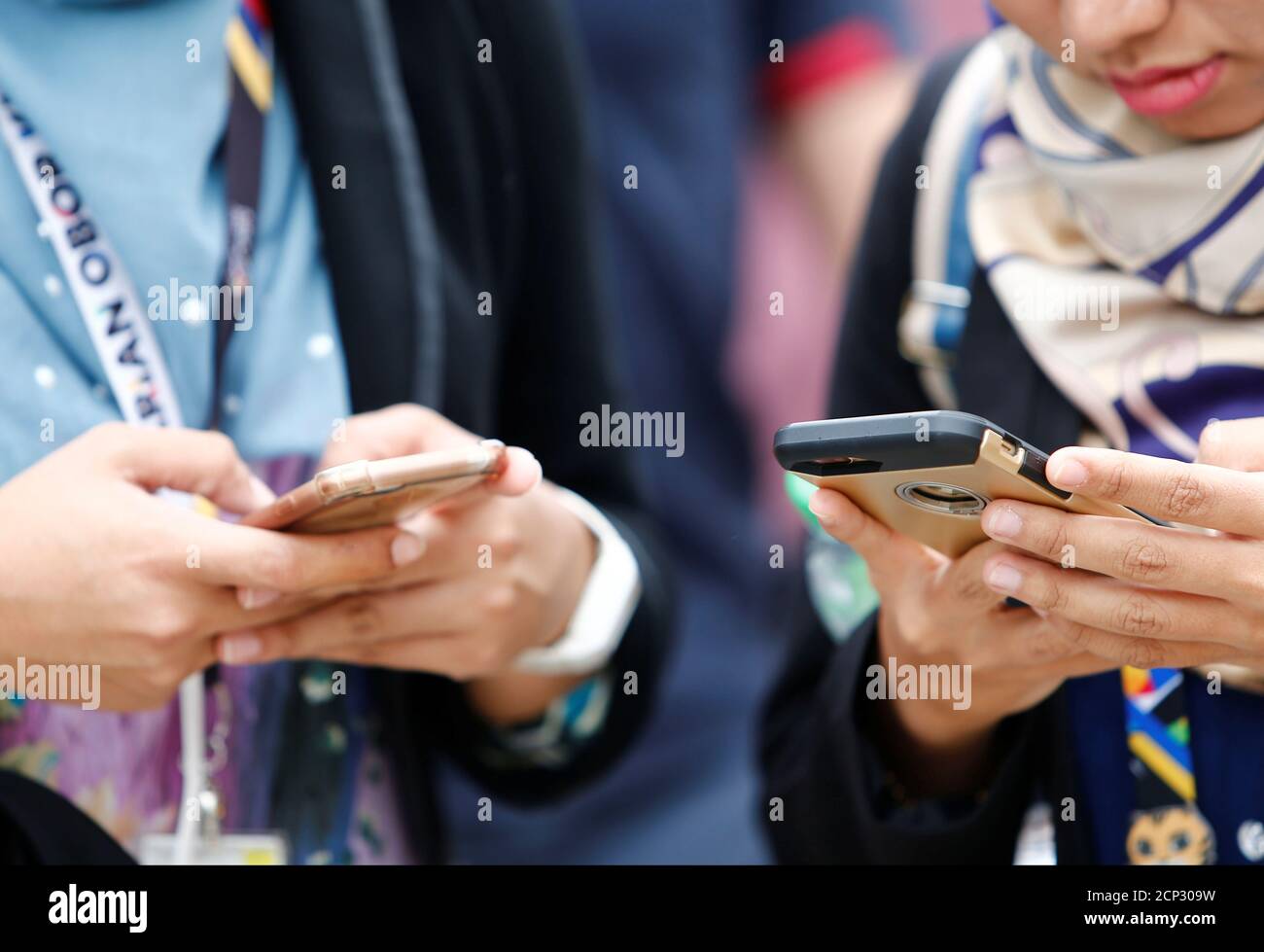 People use their mobile phones at a university in Semenyih, outside Kuala Lumpur, Malaysia November 3, 2017. REUTERS/Lai Seng Sin Stock Photo