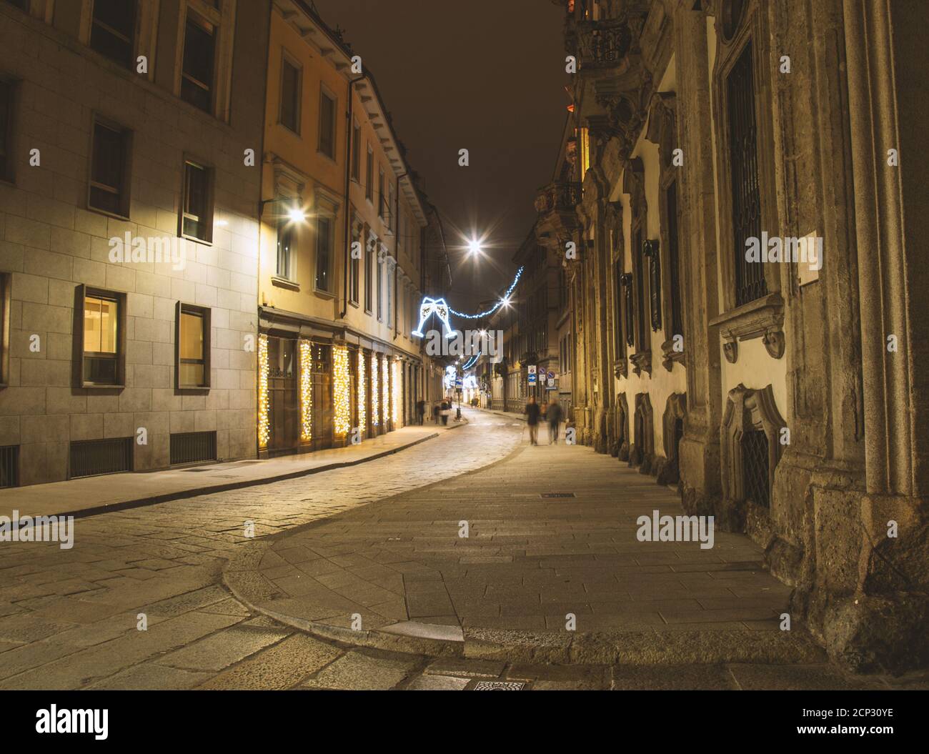 Deserted street with Xmas lights. Christmas city decorations. Festive illumination in Milan center.Italy Stock Photo