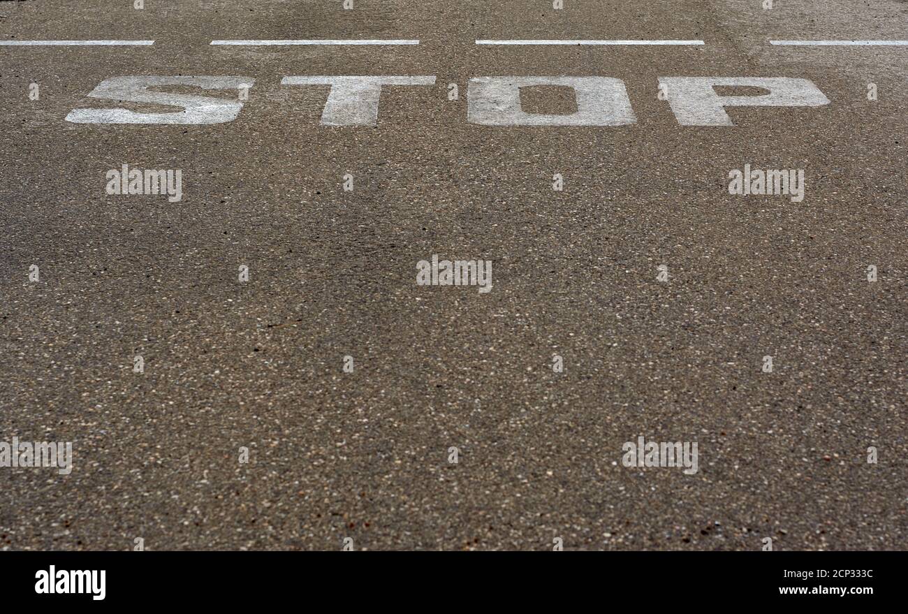 detail of stop sign painted on the asphalt Stock Photo