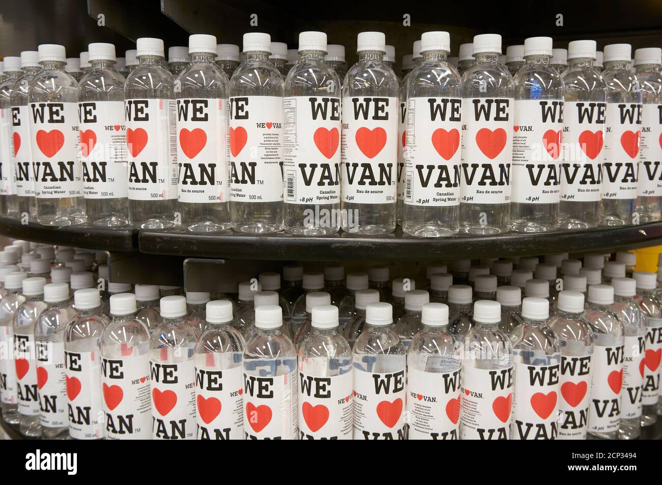 Plastic bottles of Canadian spring water lined up on a supermarket shelf in Vanvouver, British Columbia, Canada Stock Photo