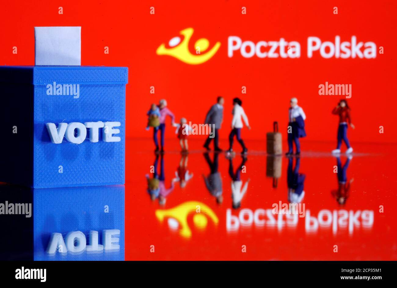 A 3D printed ballot box and toy people figures are seen in front of displayed Poczta Polska logo in this illustration taken May 4, 2020. REUTERS/Dado Ruvic/Illustration Stock Photo