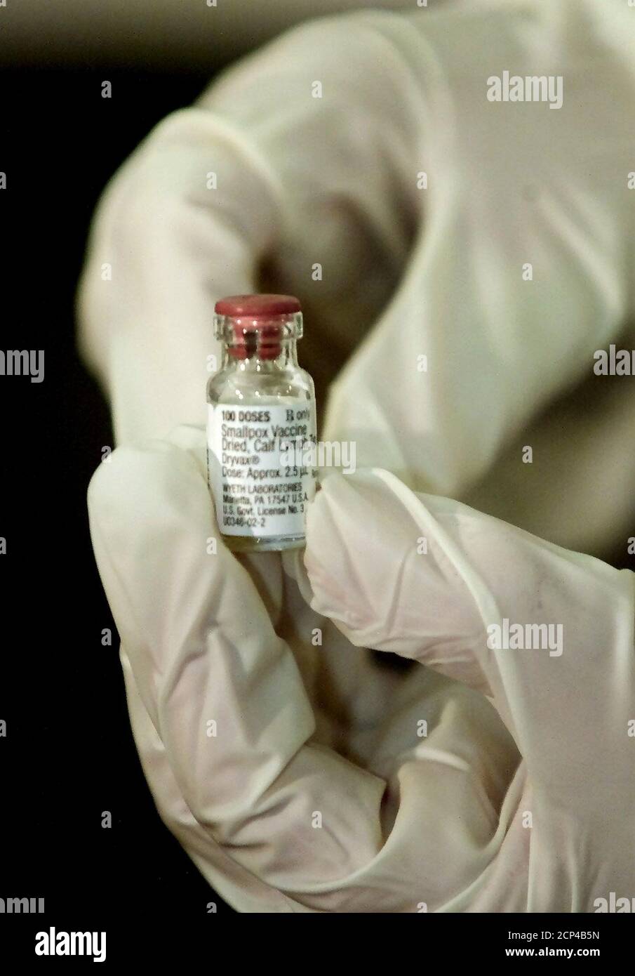 A doctor at the University of Connecticut Health Center holds the smallpox vaccine used to inoculate volunteer health care workers January 24, 2003 in Farmington, Connecticut. The doctors vaccinated today in Connecticut are the first volunteer participants in the U.S. Government's national plan to vaccinate up to 500,000 health care workers and emergency workers against the dangers of a smallpox outbreak that might result from a terror attack. REUTERS/Jim Bourg  JRB Stock Photo