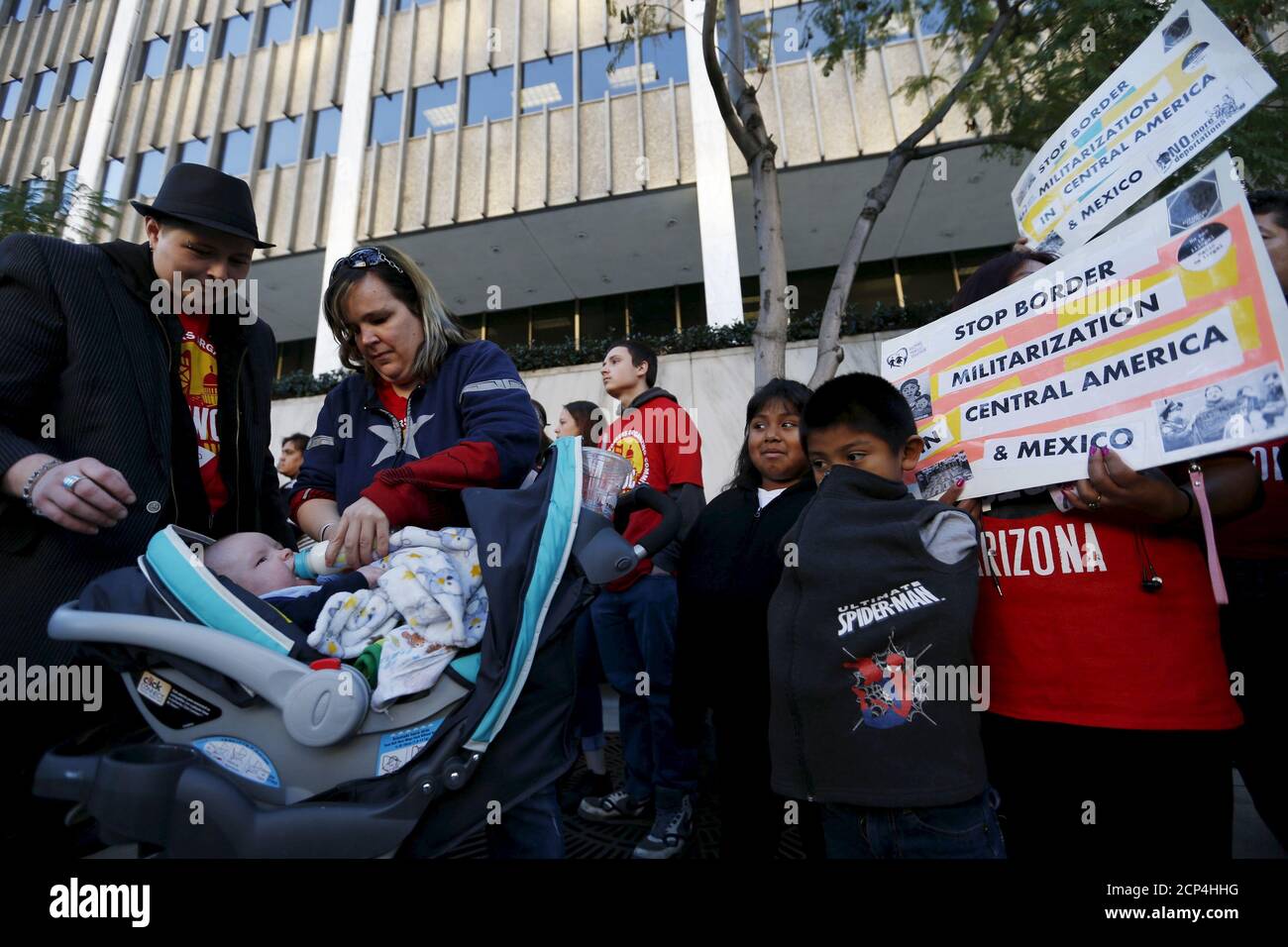 Holly Dias feeds her son Raiden Bailey as people gather outside a Federal Building while protesting against Immigration and Customs Enforcement (ICE) raids on Central American refugees in Los Angeles, California, January 26, 2016.   REUTERS/Mario Anzuoni Stock Photo