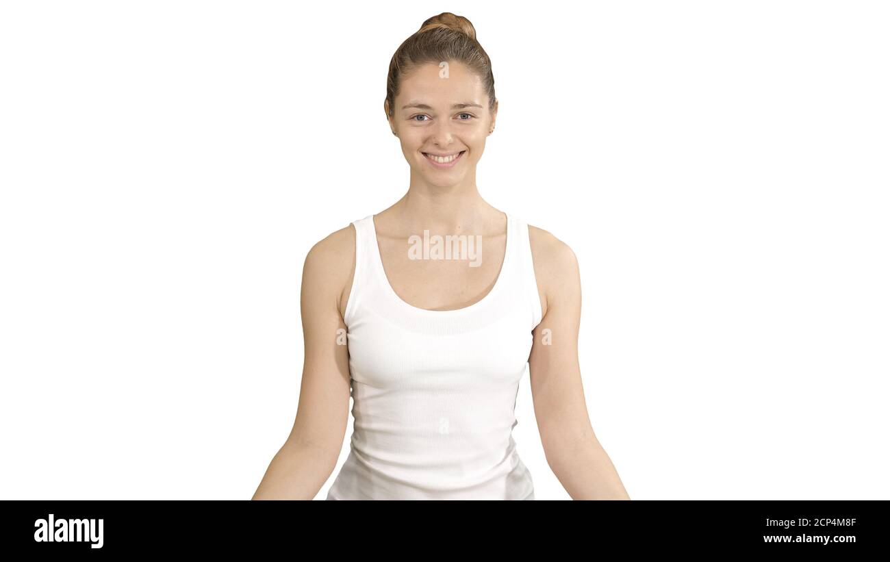 Young woman sitting in lotus pose and meditating with closed eyes on ...