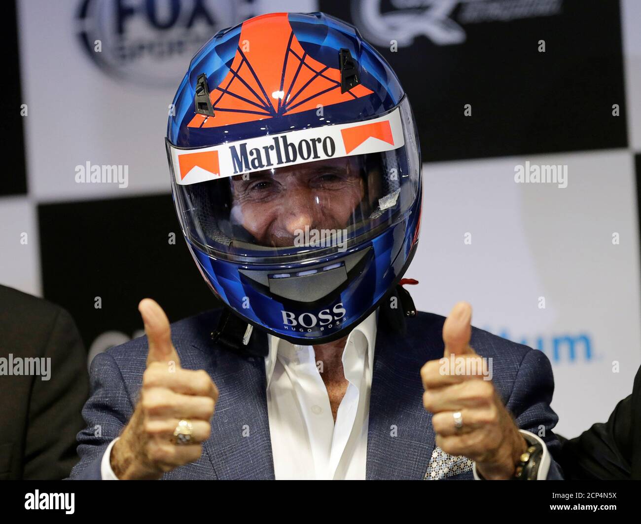 Former Brazilian Formula One driver Emerson Fittipaldi poses with a helmet during a news conference about F1- FanZone in Mexico City, Mexico September 27, 2016. REUTERS/Henry Romero Stock Photo