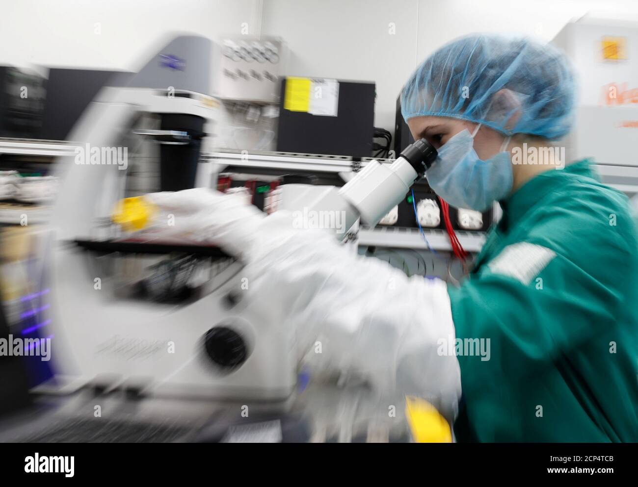 A scientist examines COVID-19 infected cells under a microscope during research for a vaccine against the coronavirus disease (COVID-19) at a laboratory of BIOCAD biotechnology company in Saint Petersburg, Russia May 20, 2020. REUTERS/Anton Vaganov Stock Photo