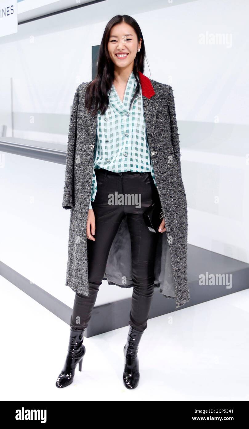 Model Liu Wen poses before the Spring/Summer 2016 women's ready-to-wear  collection for fashion house Chanel at the Grand Palais which is  transformed into a Chanel airport during the Fashion Week in Paris,
