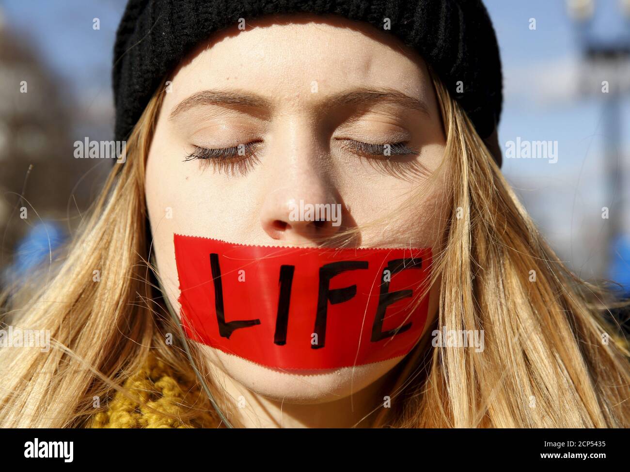A protester with her mouth taped over with the word 'life' stands in front of the U.S. Supreme Court on the morning the court takes up a major abortion case focusing on whether a Texas law that imposes strict regulations on abortion doctors and clinic buildings interferes with the constitutional right of a woman to end her pregnancy, in Washington March 2, 2016. REUTERS/Kevin Lamarque       TPX IMAGES OF THE DAY Stock Photo