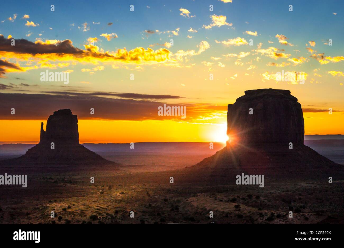 Monument Valley mitten buttes with sunburst at sunset, Utah, USA. Stock Photo