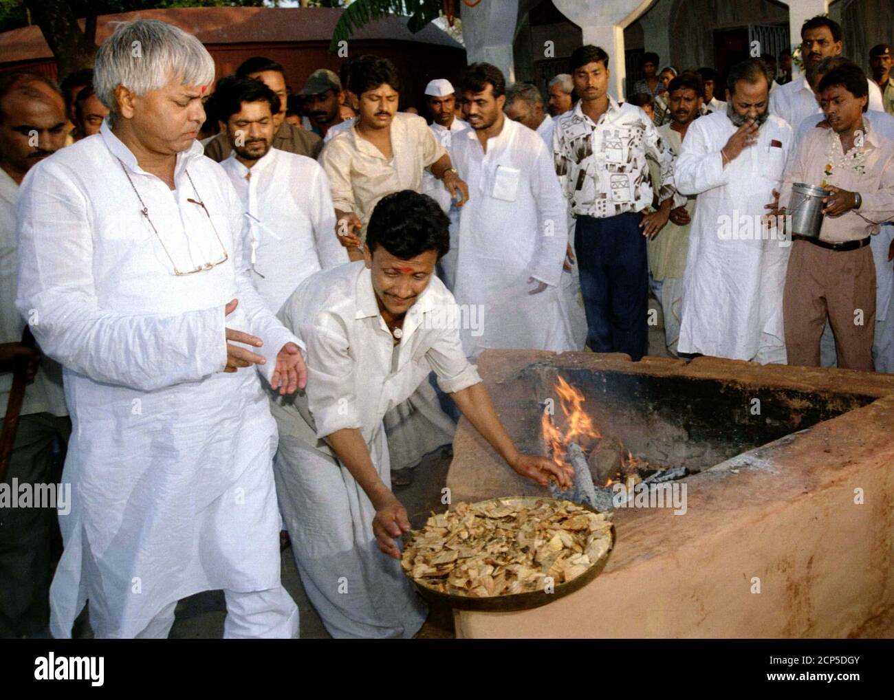 Laloo Prasad Yadav (L), chief minister of the eastern Indian state of Bihar,  offer prayers at a temple in the state capital Patna on June 21. Yadav,  head of Prime Minister Inder