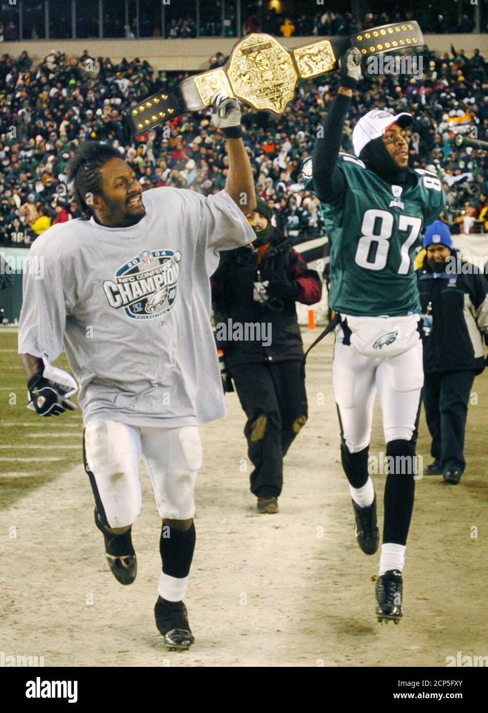 Philadelphia Eagles wide receiver Freddie Mitchell (L) and teammate wide  receiver Todd Pinkston hold up a wrestling belt celebrating their team  winning the NFC championship against the Atlanta Falcons, in Philadelphia  January