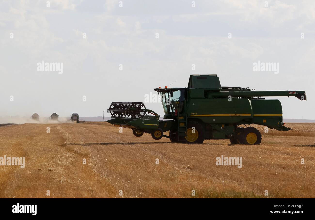 John Deere combine harvests wheat in a field of the Oktyabrskoe farming company in Akmola region, Kazakhstan, September 5, 2016.  REUTERS/Shamil Zhumatov Stock Photo