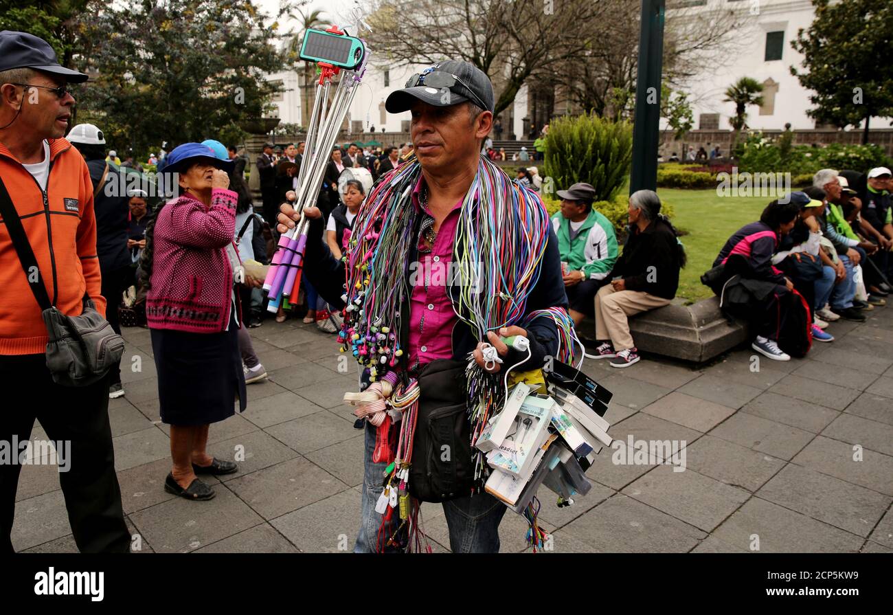Adan Haro sells cellphone accessories at the main square in Quito, Ecuador March 30, 2017. REUTERS/Mariana Bazo Stock Photo